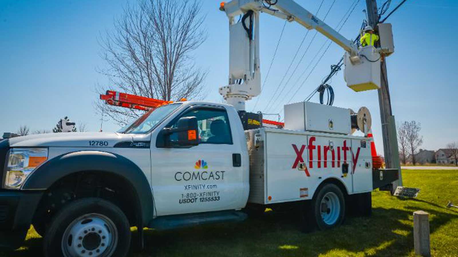 Comcast tech on truck at wires