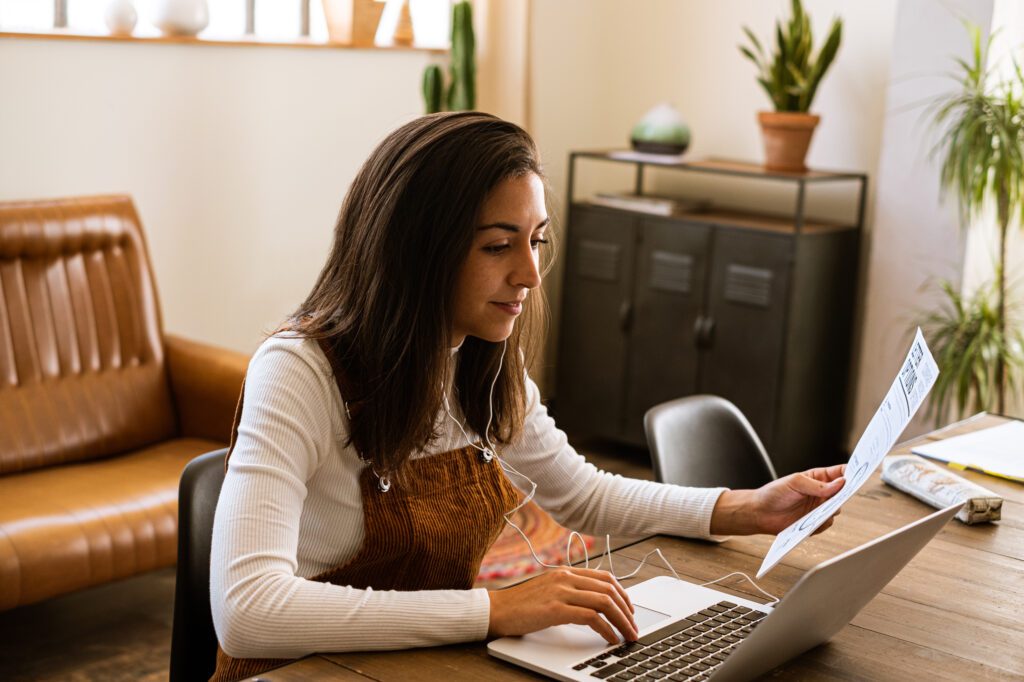 A young women at a laptop experiencing the recent expansion of the Xfinity network allowing for fast and reliable Internet.