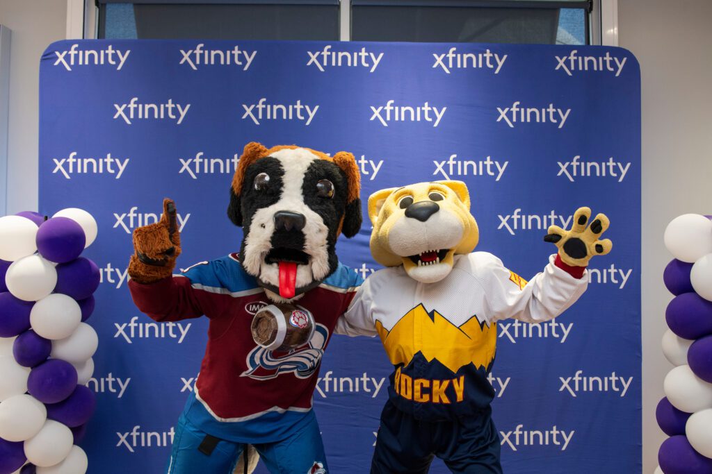 Bernie and Rocky, mascots for the Colorado Avalanche and Denver Nuggets, posing inside of the new Xfinity store in Fort Collins.