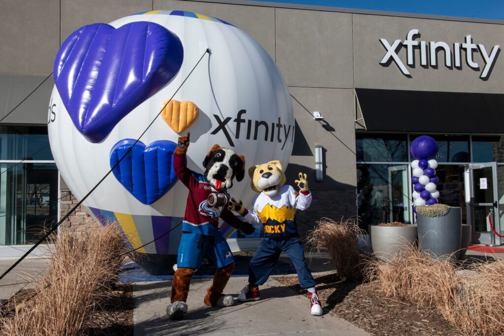 Bernie and Rocky, mascots for the Colorado Avalanche and Denver Nuggets, posing outside of the new Xfinity store in Fort Collins.