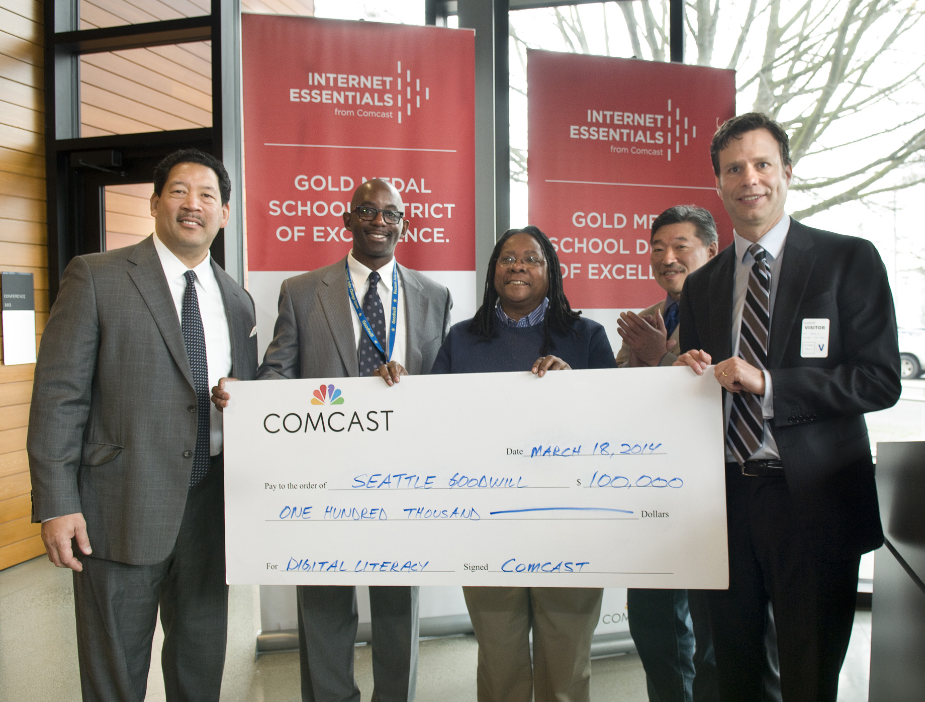 L to R Seattle City Councilmember Bruce Harrell, Markee Foster and B.G. Nabors-Glass with Goodwill, State Sen. Bob Hasegawa and Comcast VP Steve Kipp present Goodwill with $100,000 