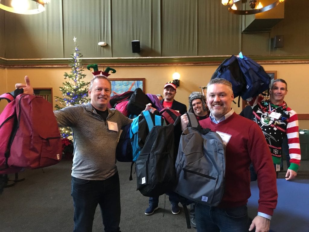 Comcast Washington state executives pack holiday kits for the homeless and Mary's Place