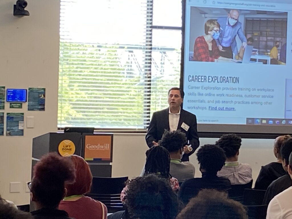Comcast's Rodrigo Lopez speaks to a crowd at Evergreen Goodwill's King County Job Training and Education Center