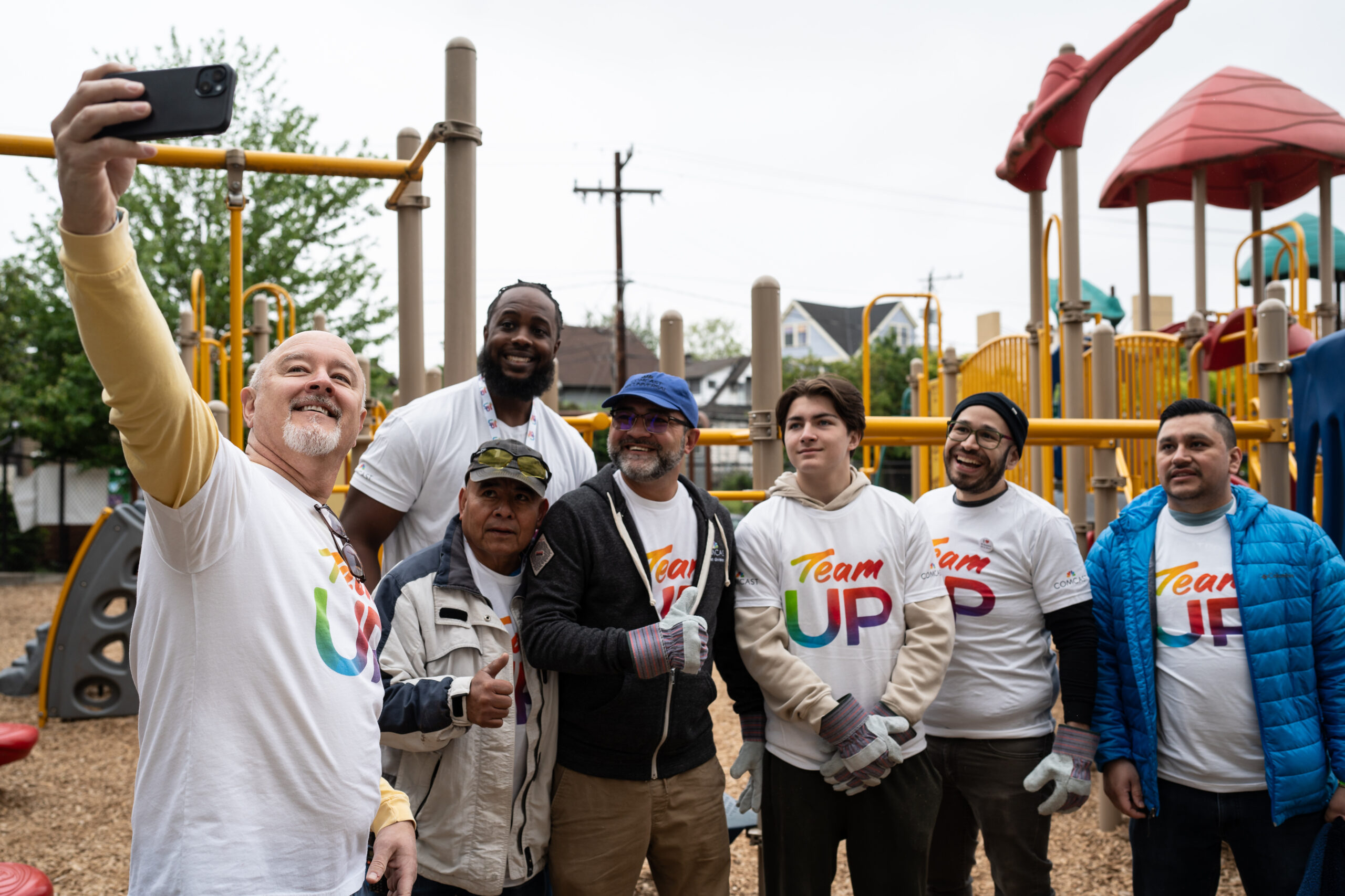 Comcast volunteers pose for a photo in a playground.