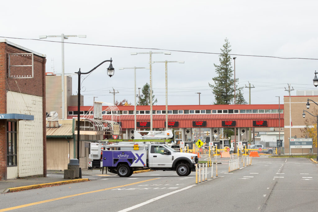 An Xfinity truck drives by the Canadian border in Sumas.