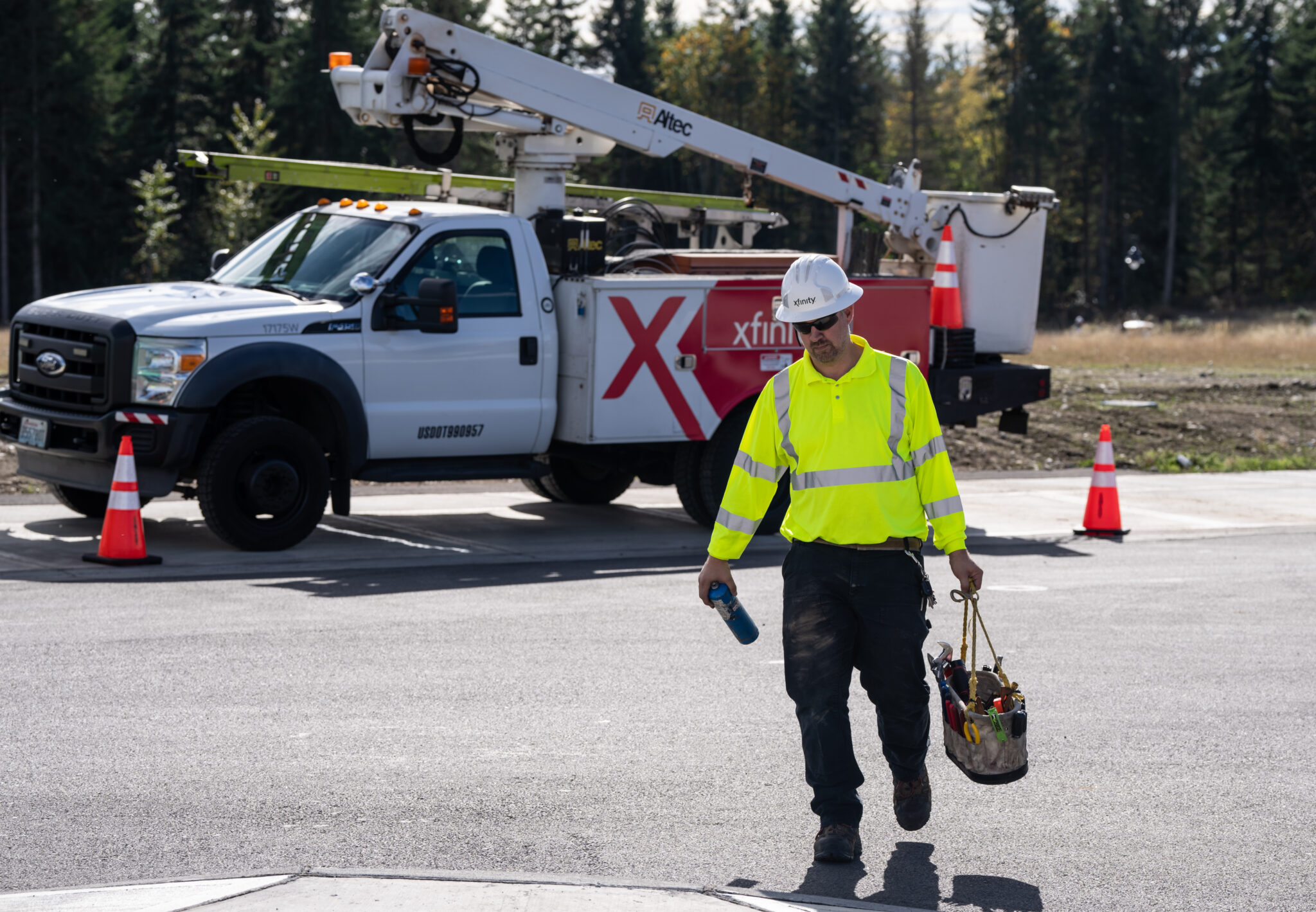 A Comcast technician in front of a Comcast van.