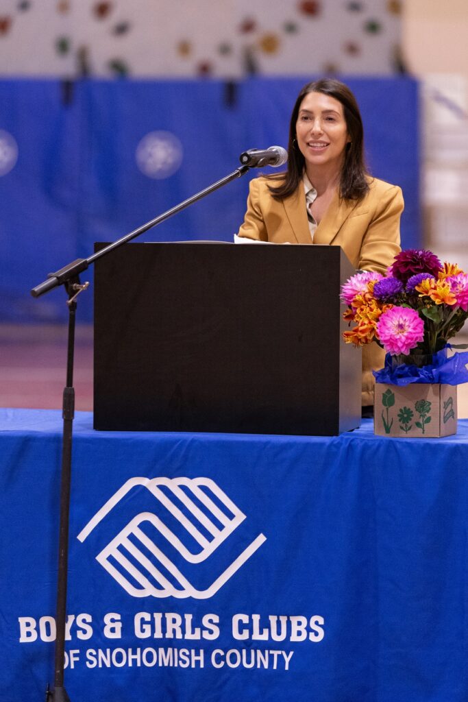 Carla Carrell of Comcast speaks at a podium.