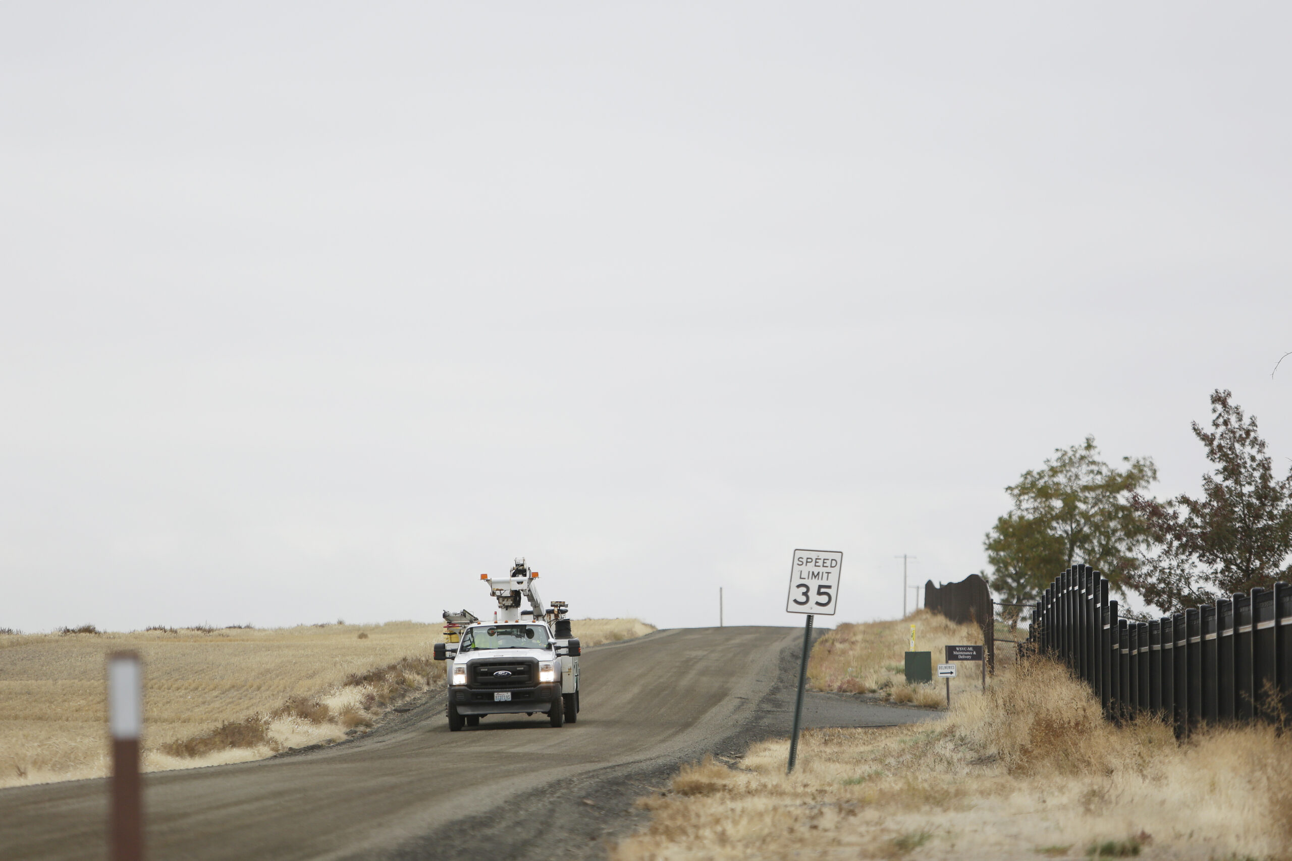 A Comcast truck drives on a road in Spokane County.