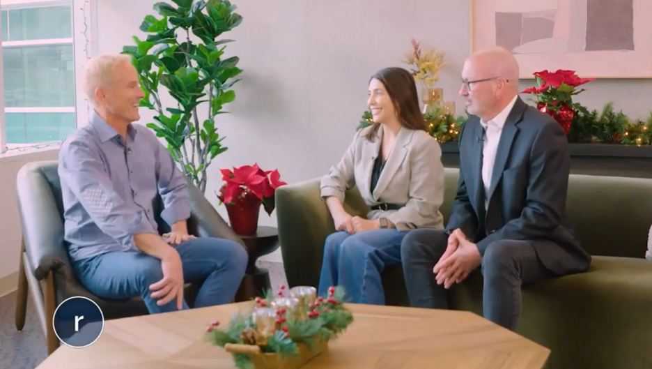 Three people sit at a couch and chair.