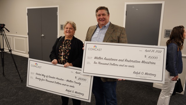 Grant recipients holding ceremonial checks and smiling toward the camera