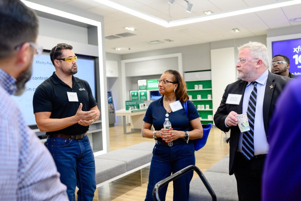 Comcast representatives talks to elected officials at Xfinity store