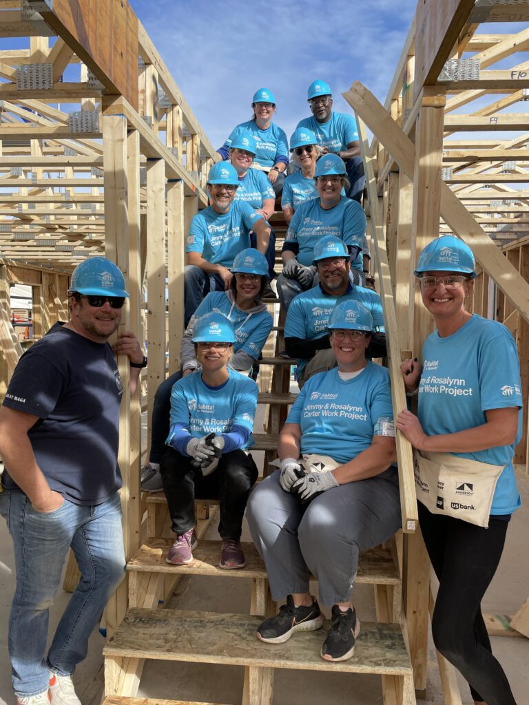 Group of Comcast employees volunteering at Habitat for Humanity