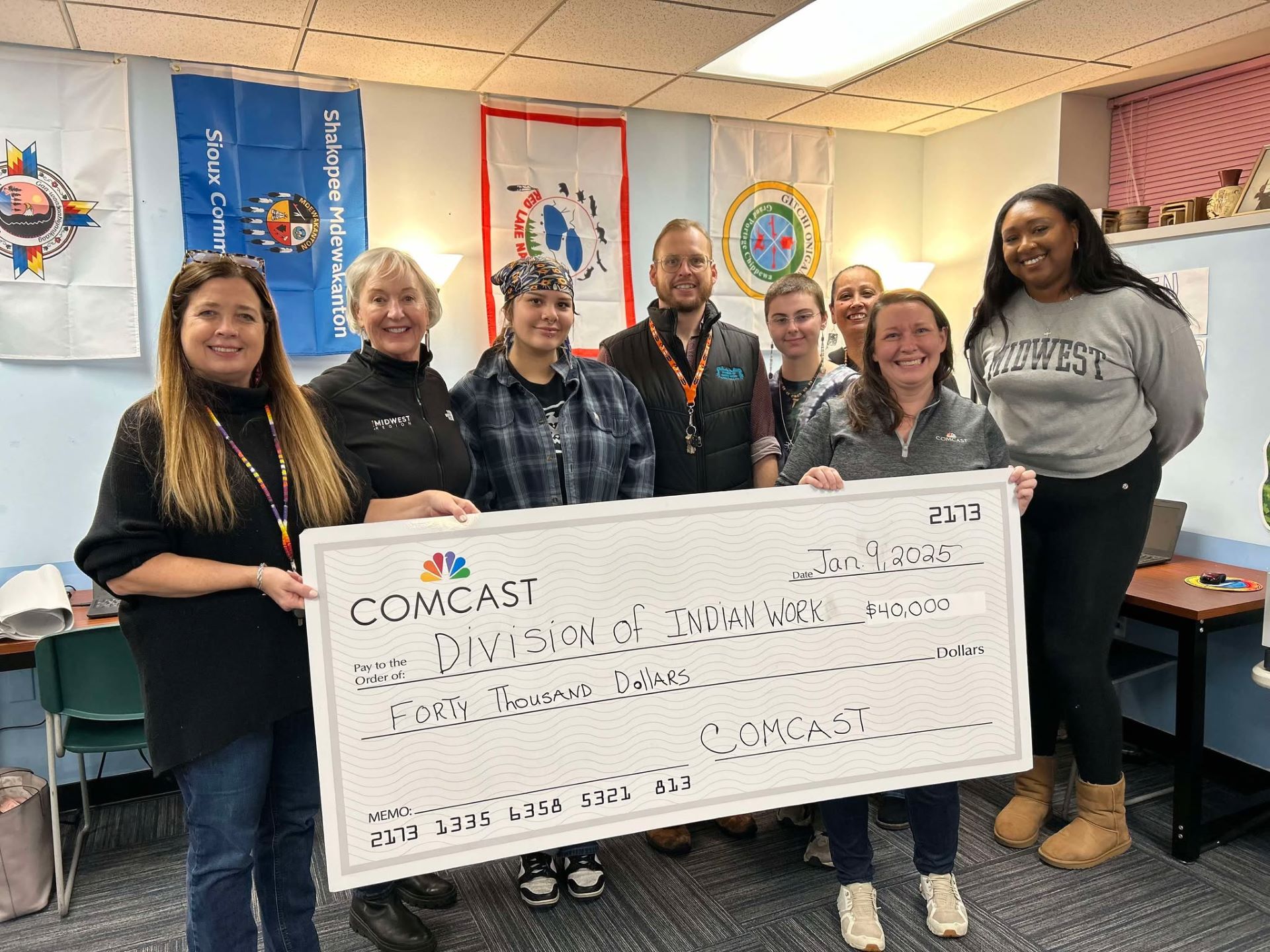 Staff of Division of Indian Work and Comcast holding check