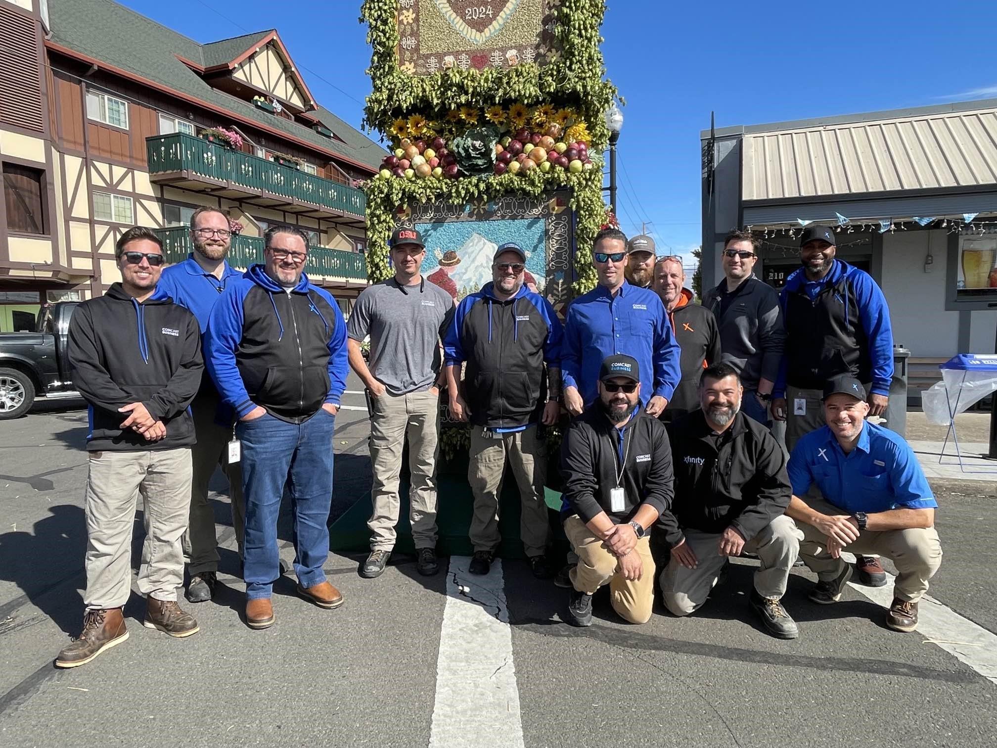 A group of Comcast Technicians pose and smile at the Mt. Angel Oktoberfest.