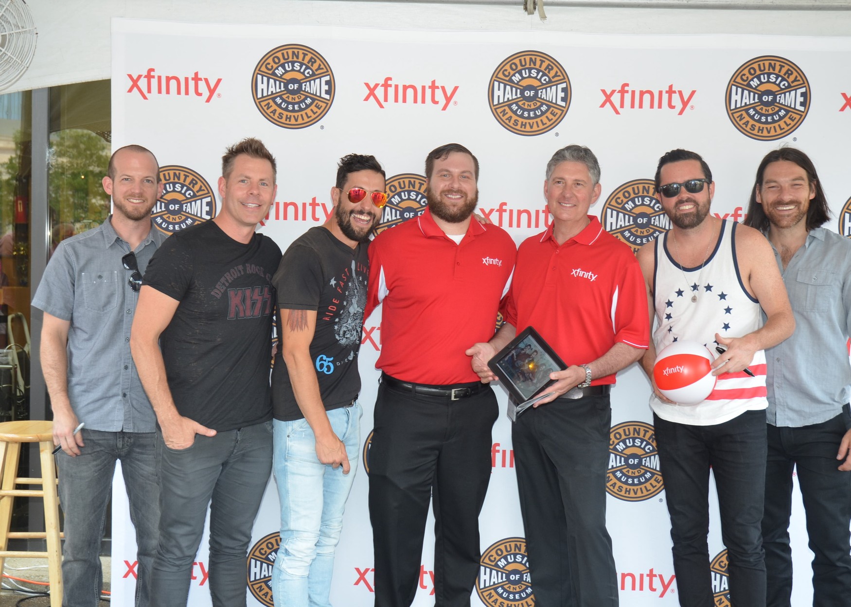 Xfinity team members smiling during a CMA photo-op.