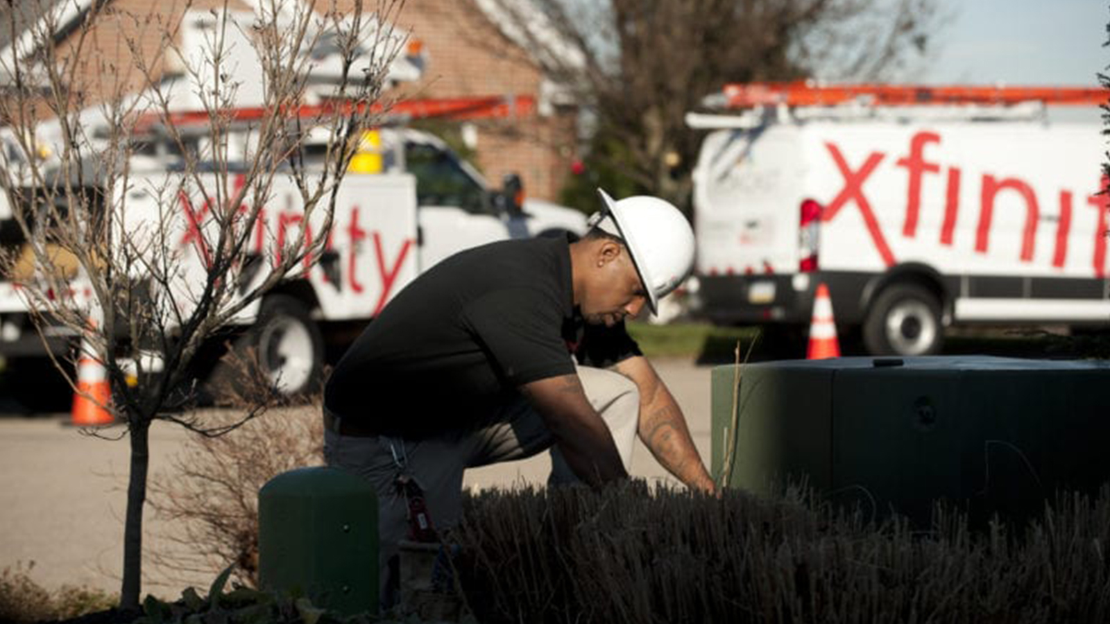 Comcast technician works at Comcast facility.