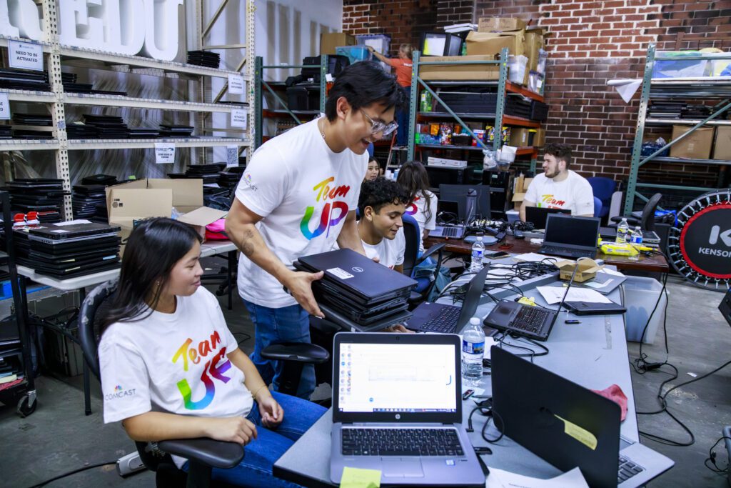 Comcast interns volunteer at a Team UP event in Atlanta, GA at a digital equity community partner.