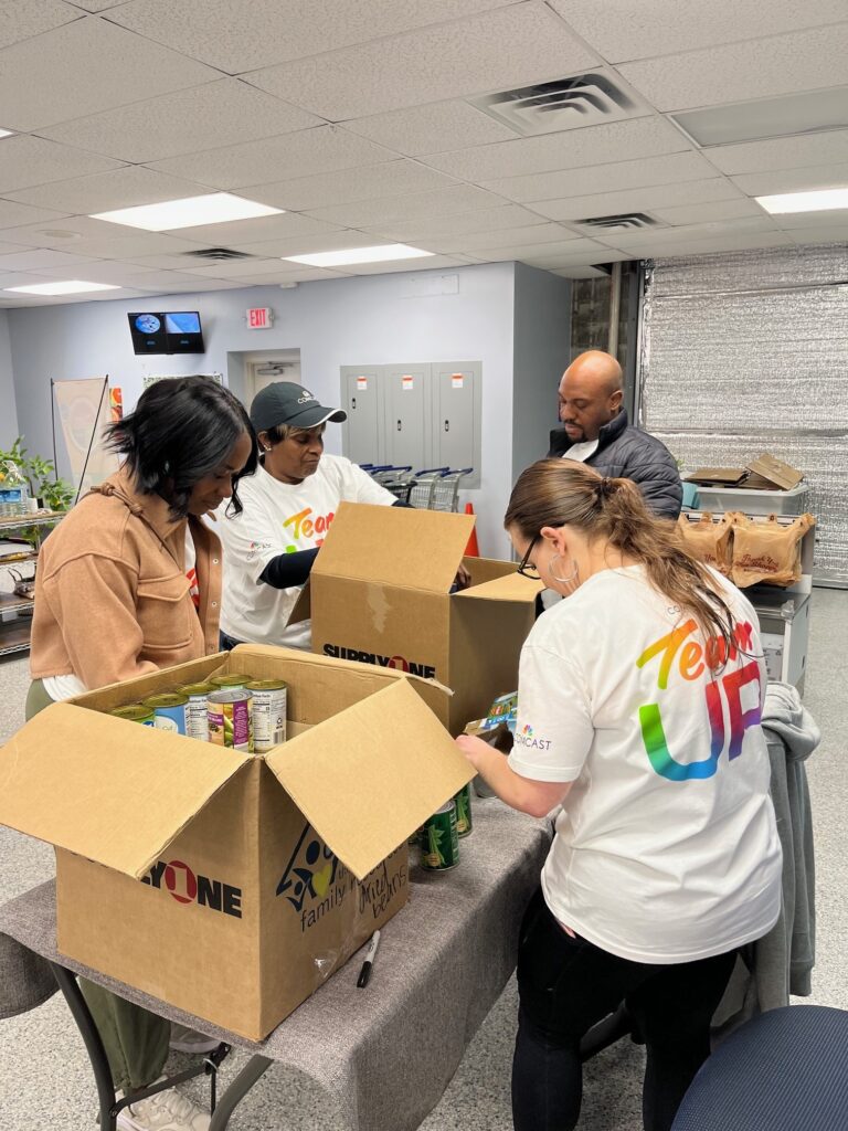 Members packing boxes at a volunteer event, Women's History Month, how to celebrate women's history month