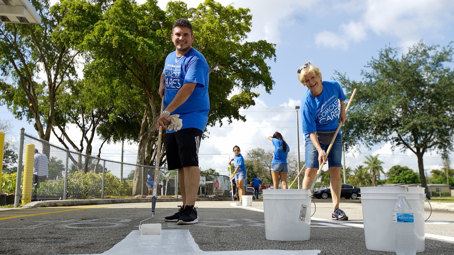 Comcast Cares Day volunteers paint a playground.