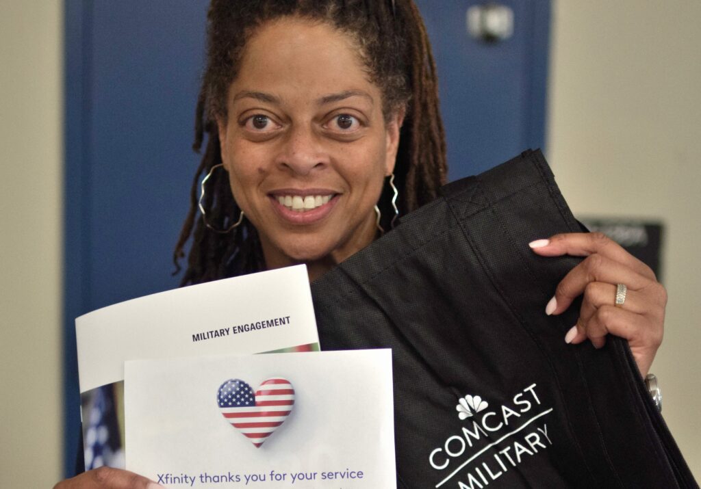 woman posing for a picture with a paper in hand