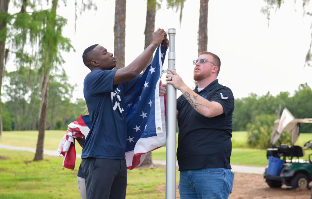 Grant Holloway participates in flag retirement ceremony.