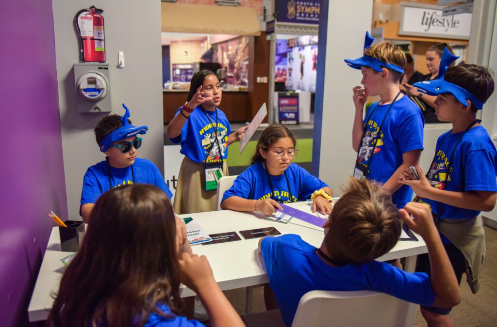 Student leads a staff meeting at the JA Xfinity Store