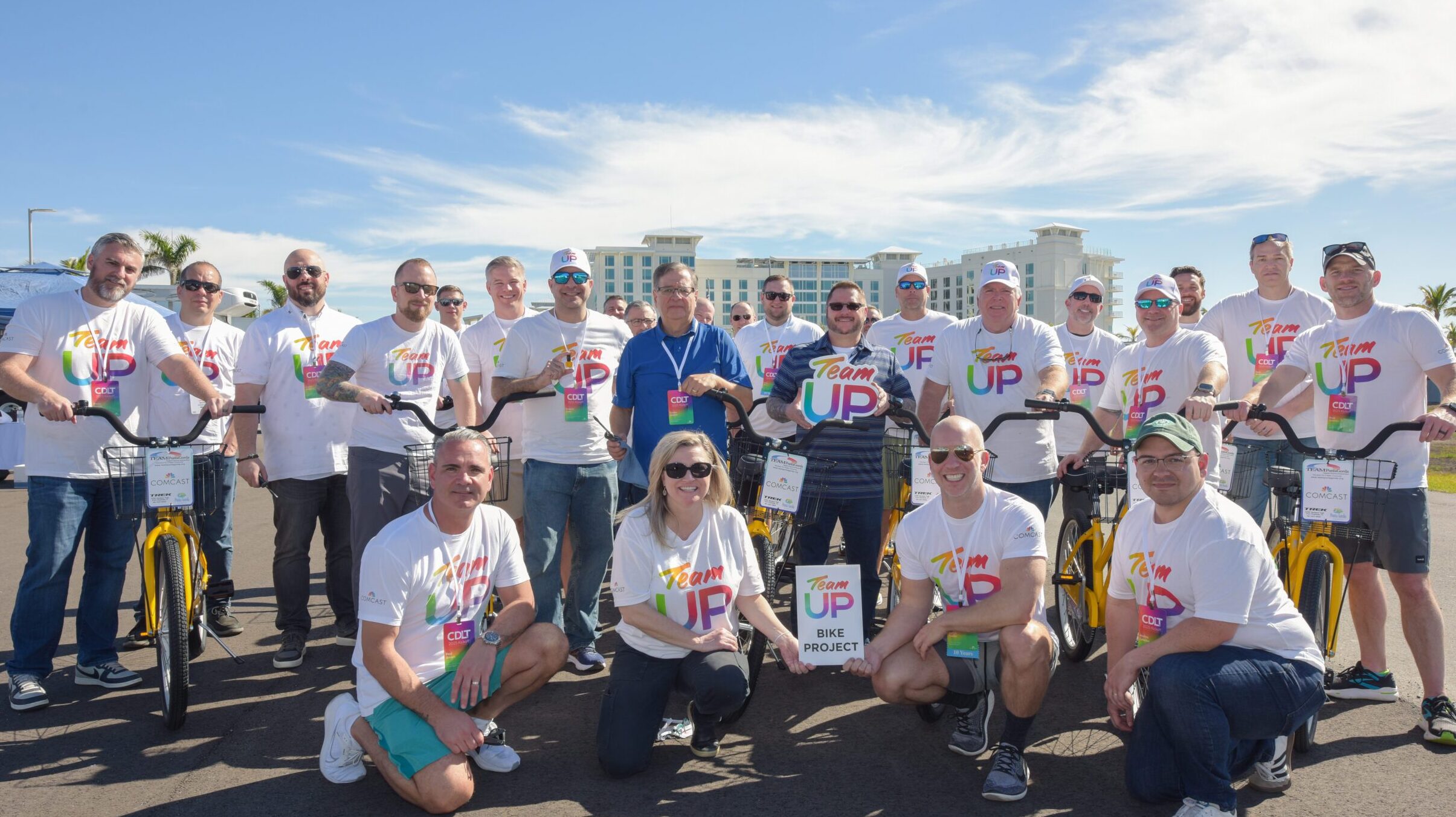 group of people pose for a picture with bikes