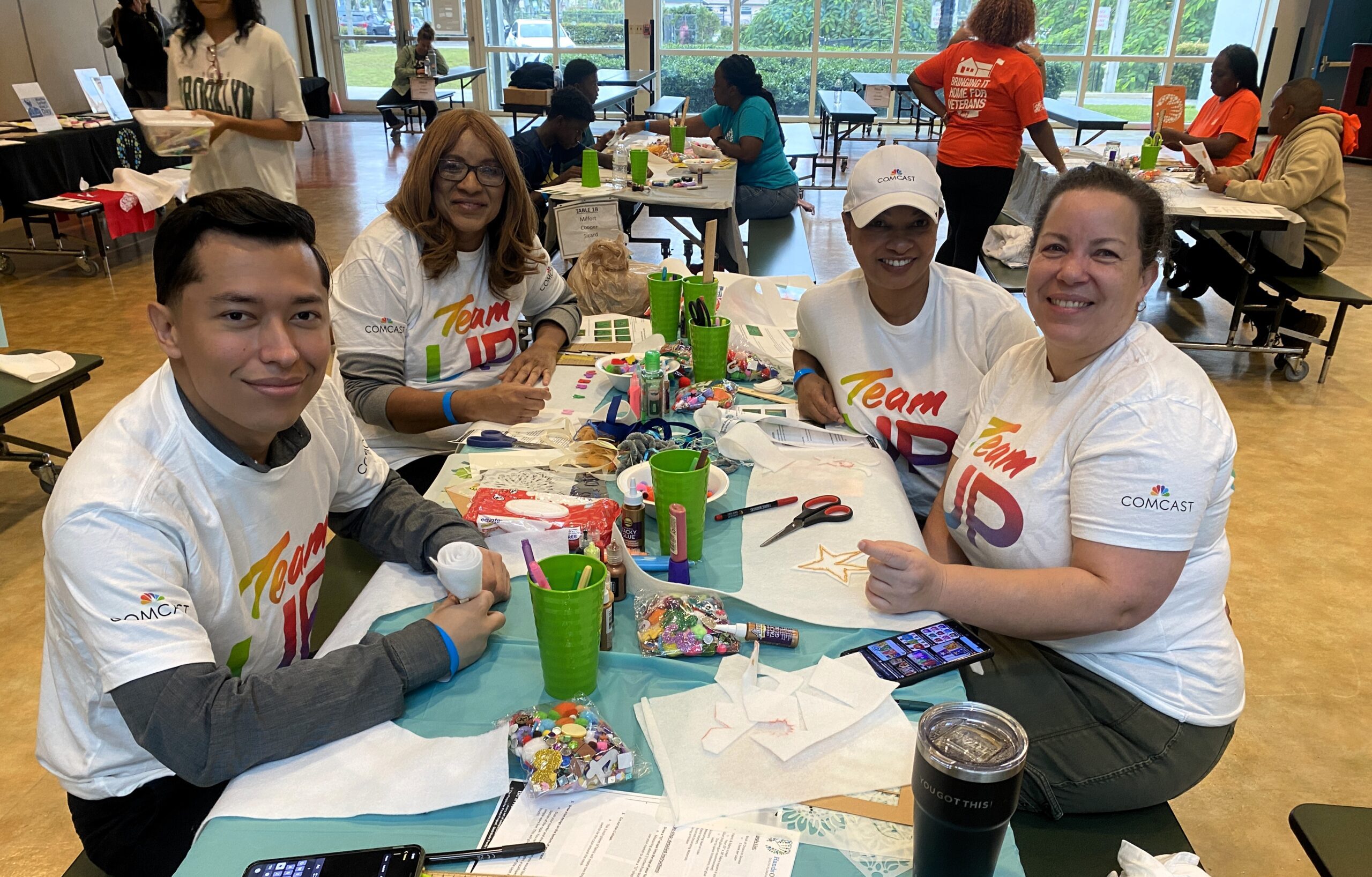 Comcast volunteers package books for students