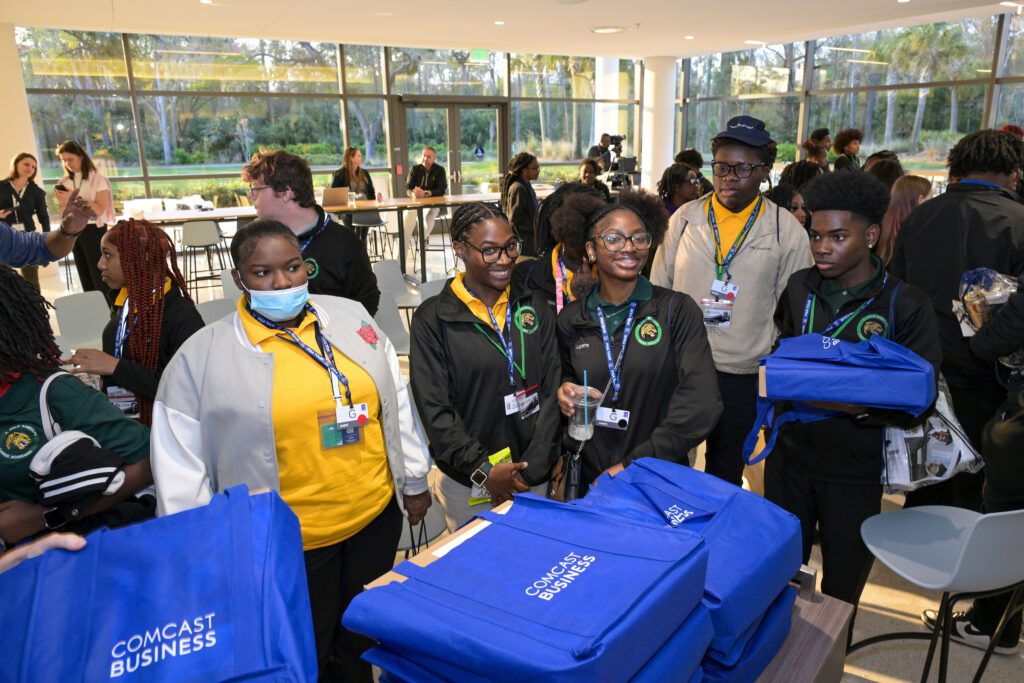 Duval County students receive new laptops at the Tee Up Your Future event.