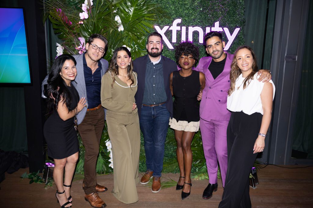 Seven people posing for a picture