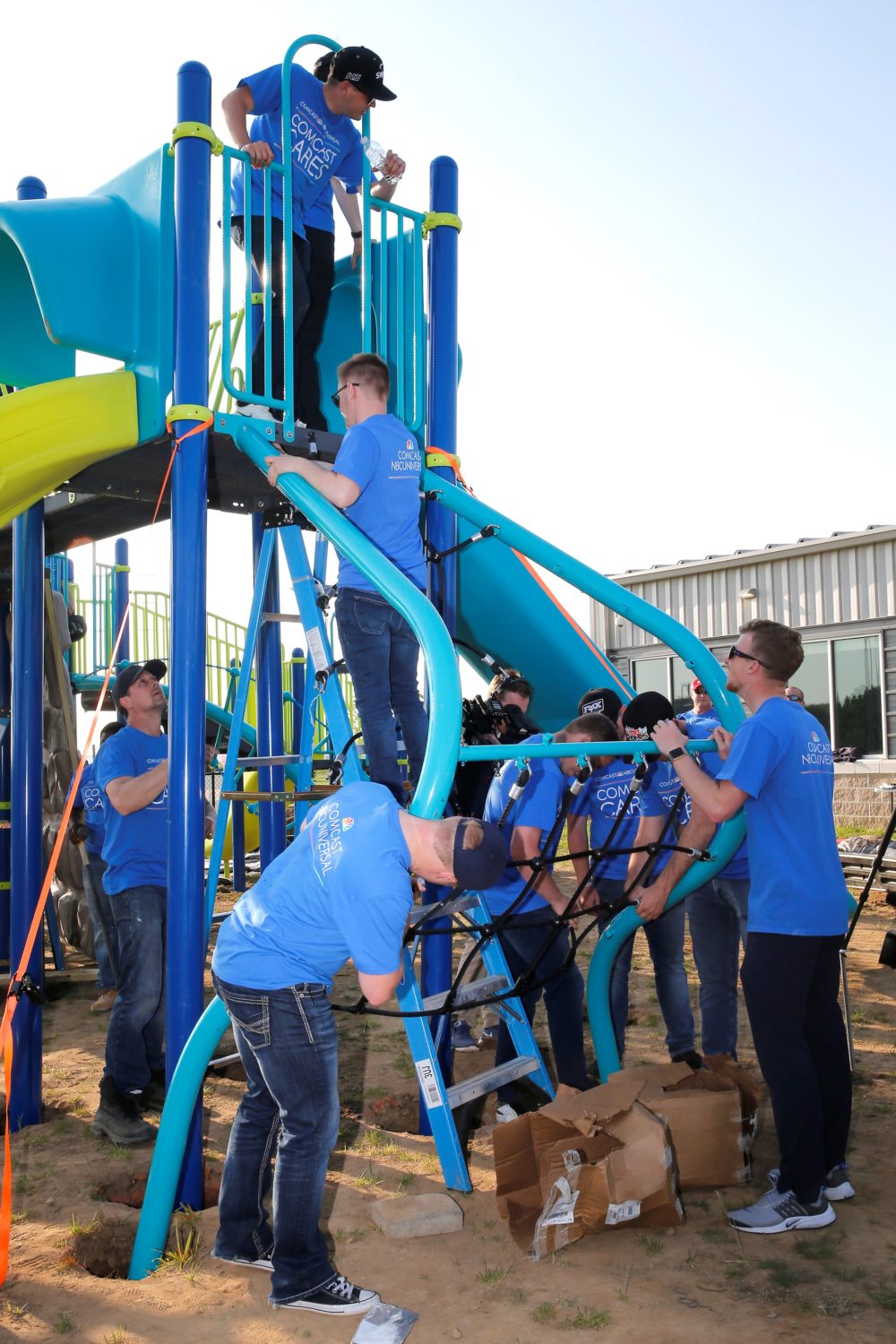Volunteers working on playground equipment