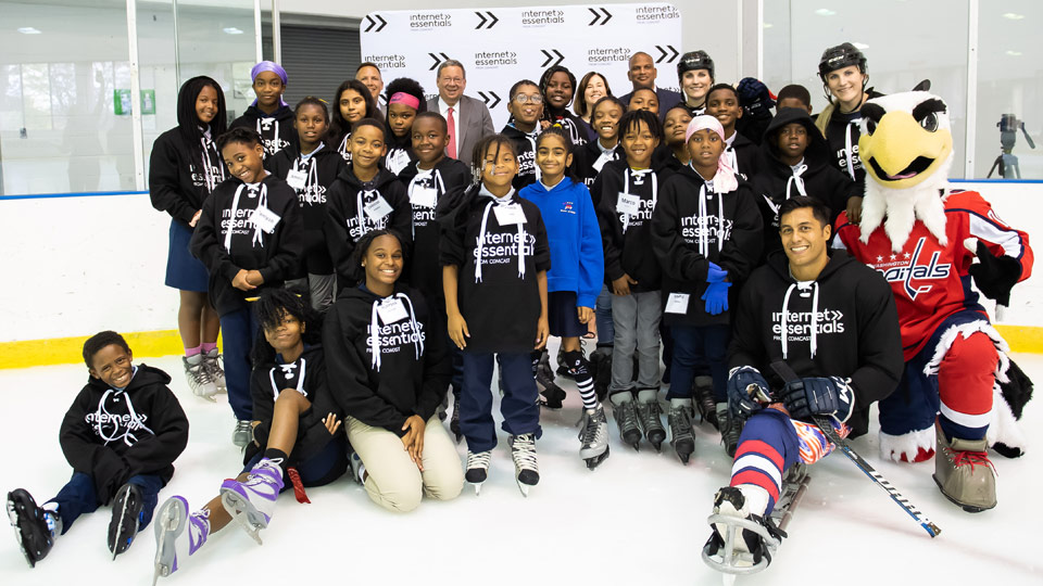 Rico Roman and Internet Essentials participants on the ice at an event in Washington D.C.