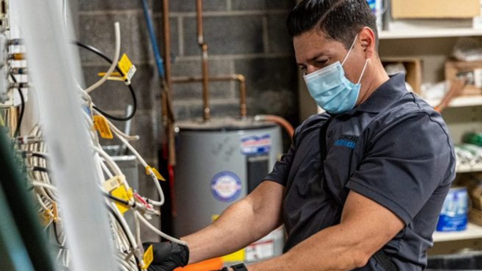 An employee working and wearing a mask.