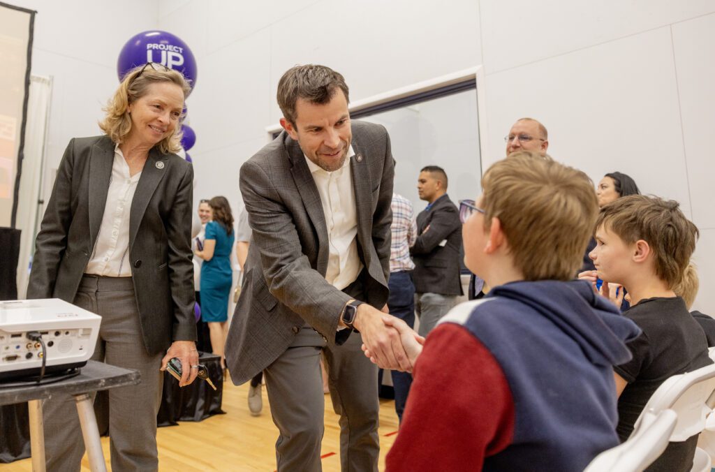 Jim Grover, Governor’s Office of Economic Opportunity, Managing Director of Economic Growth for the State of Utah greets kids before the Lift Zone Technology Center Ribbon Cutting ceremony at the Boys & Girls Club of Greater Salt Lake on Wednesday, May 22, 2024 in Tooele, UT. 