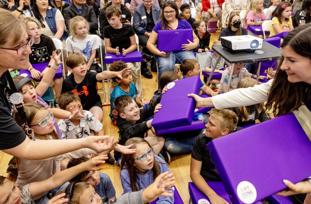 Kids from the Tooele Boys & Girls Club react to being given laptops during a Lift Zone Technology Center Ribbon Cutting ceremony at the Boys & Girls Club of Greater Salt Lake on Wednesday, May 22, 2024 in Tooele, UT. 