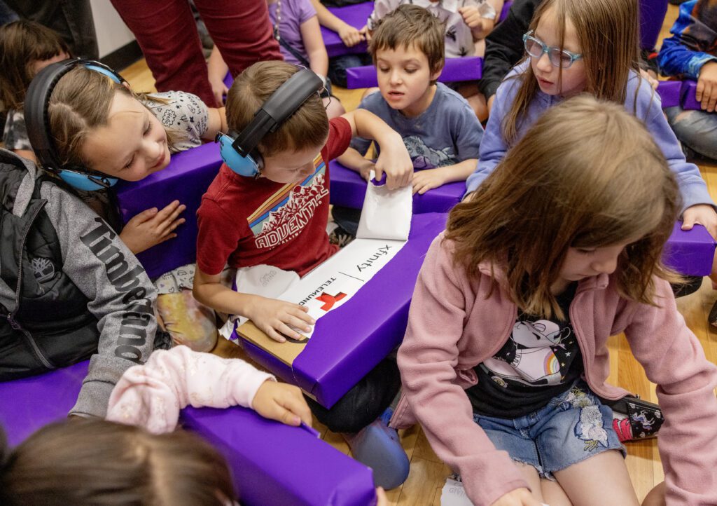 Kids from the Tooele Boys & Girls Club react to being given laptops during a Lift Zone Technology Center Ribbon Cutting ceremony at the Boys & Girls Club of Greater Salt Lake on Wednesday, May 22, 2024 in Tooele, UT. 