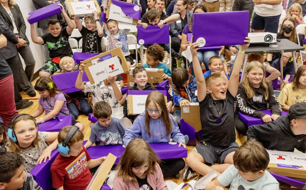 Kids from the Tooele Boys & Girls Club react to being given laptops during a Lift Zone Technology Center Ribbon Cutting ceremony at the Boys & Girls Club of Greater Salt Lake on Wednesday, May 22, 2024 in Tooele, UT. 