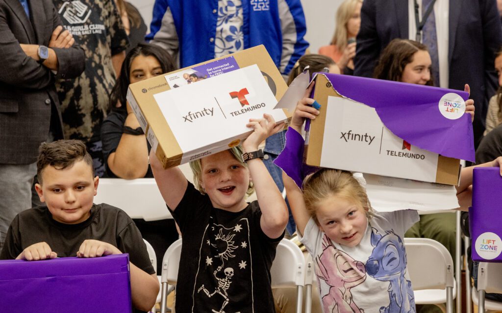 Kids from the Tooele Boys & Girls Club react to being given laptops during a Lift Zone Technology Center Ribbon Cutting ceremony at the Boys & Girls Club of Greater Salt Lake on Wednesday, May 22, 2024 in Tooele, UT.