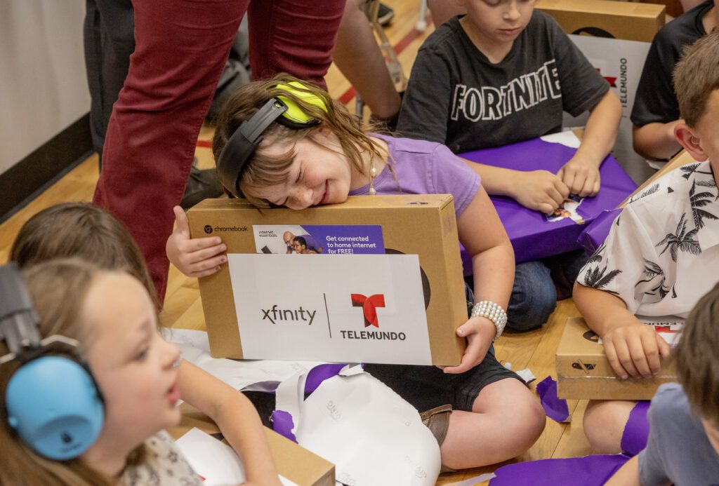 Kids from the Tooele Boys & Girls Club react to being given laptops during a Lift Zone Technology Center Ribbon Cutting ceremony at the Boys & Girls Club of Greater Salt Lake on Wednesday, May 22, 2024 in Tooele, UT. 