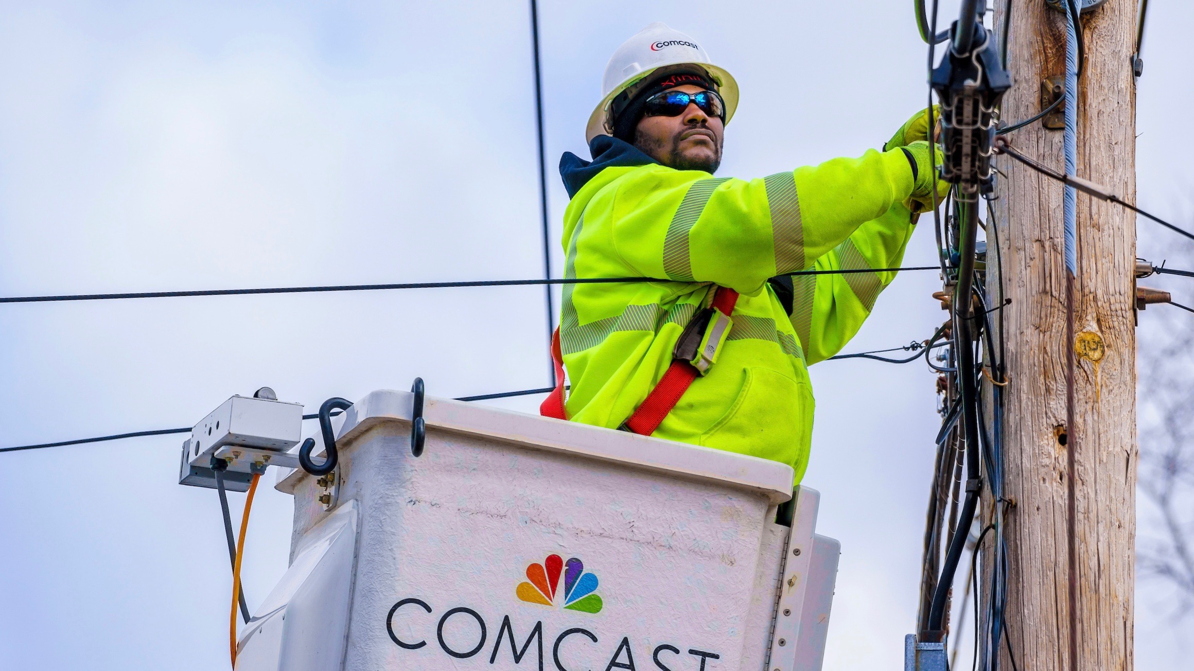 Comcast technicians seen at a construction site installation on Wednesday, Jan. 24, 2018 in Levittown, Pa. (Jeff Fusco/AP Images for Comcast)